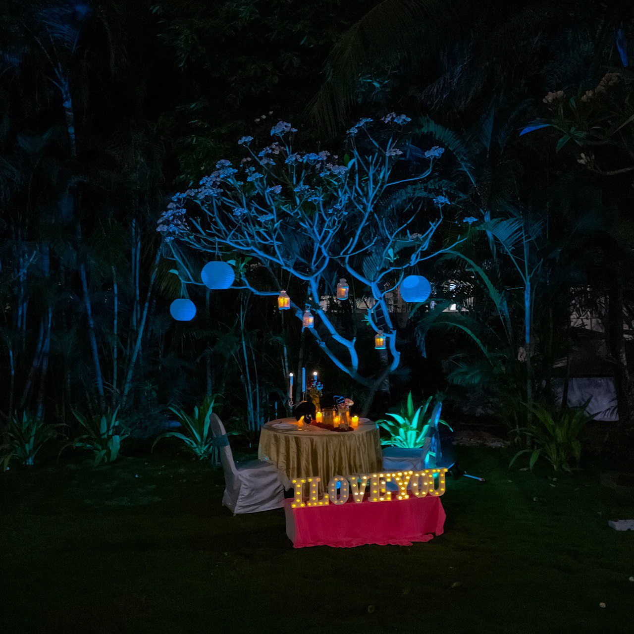 Exquisite anniversary celebration in Hyderabad with LED 'HAPPY ANNIVERSARY' lights and open-air dining.