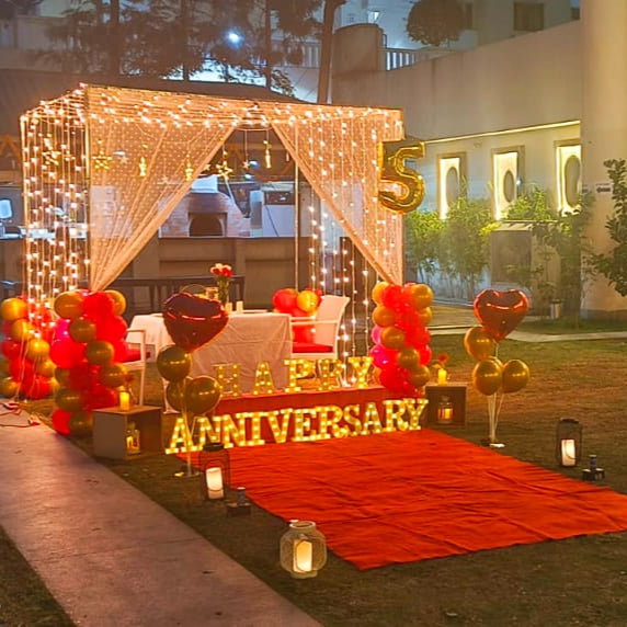 Romantic candle light dinner in Hyderabad at Ellaa Hotel with a red carpet entrance and personal Bluetooth speaker.