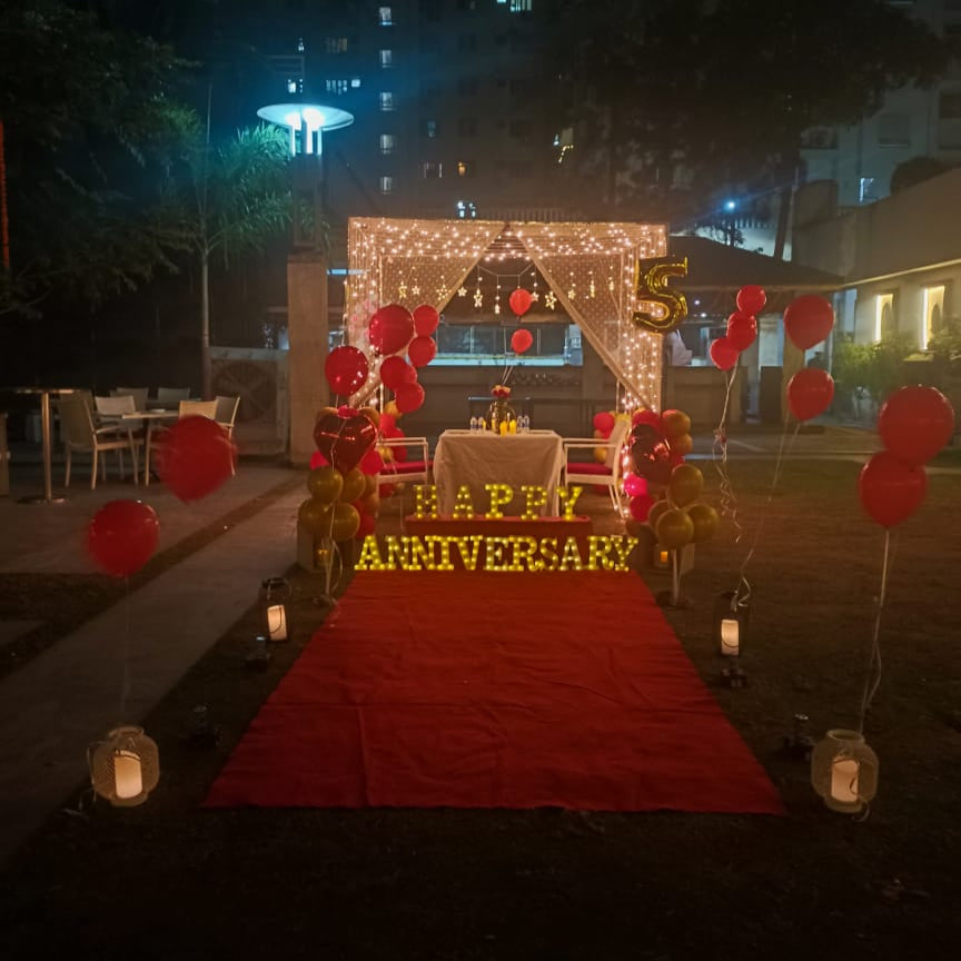 Premium cabana with candle and lamp decorations for a luxurious anniversary celebration in Hyderabad.