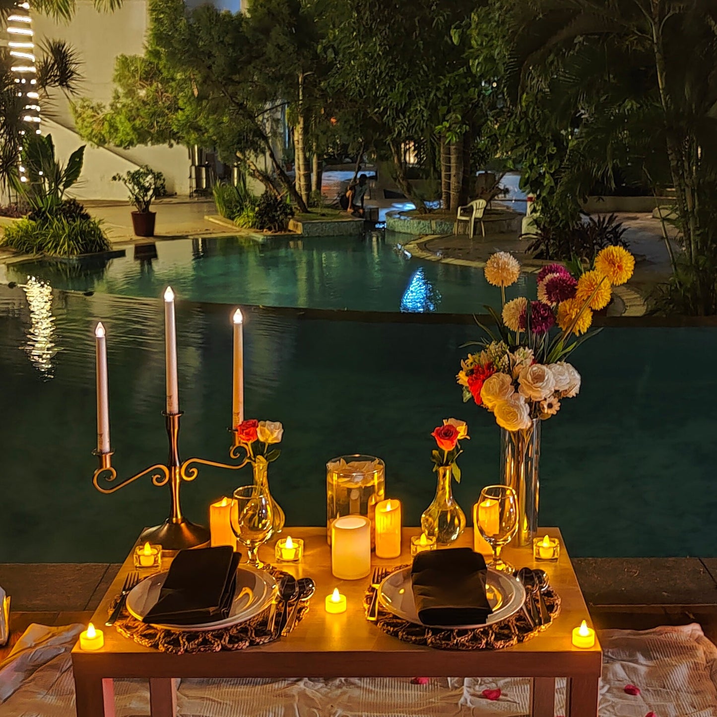 Private poolside candle light dinner in Hyderabad with stunning decor, perfect for special occasions like birthdays and anniversaries.
