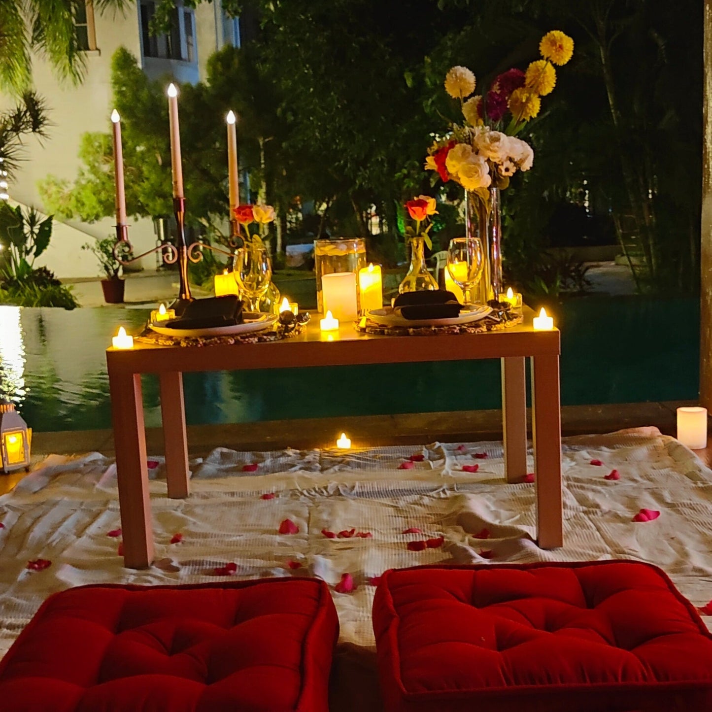 Romantic anniversary celebration in Hyderabad featuring a low-seating poolside dinner setup at The Manohar.
