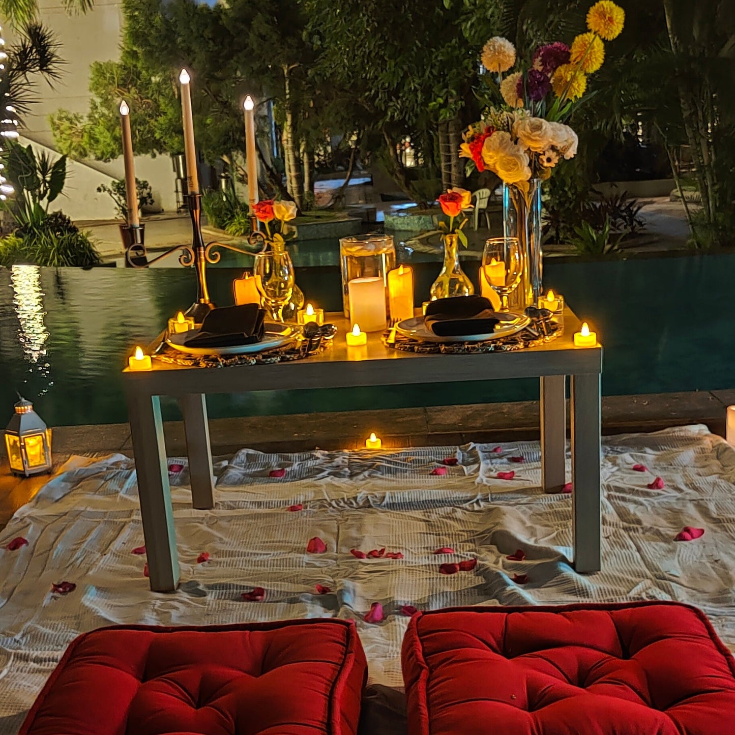 Elegant anniversary celebration in Hyderabad with a beautifully decorated poolside candle light dinner setup.