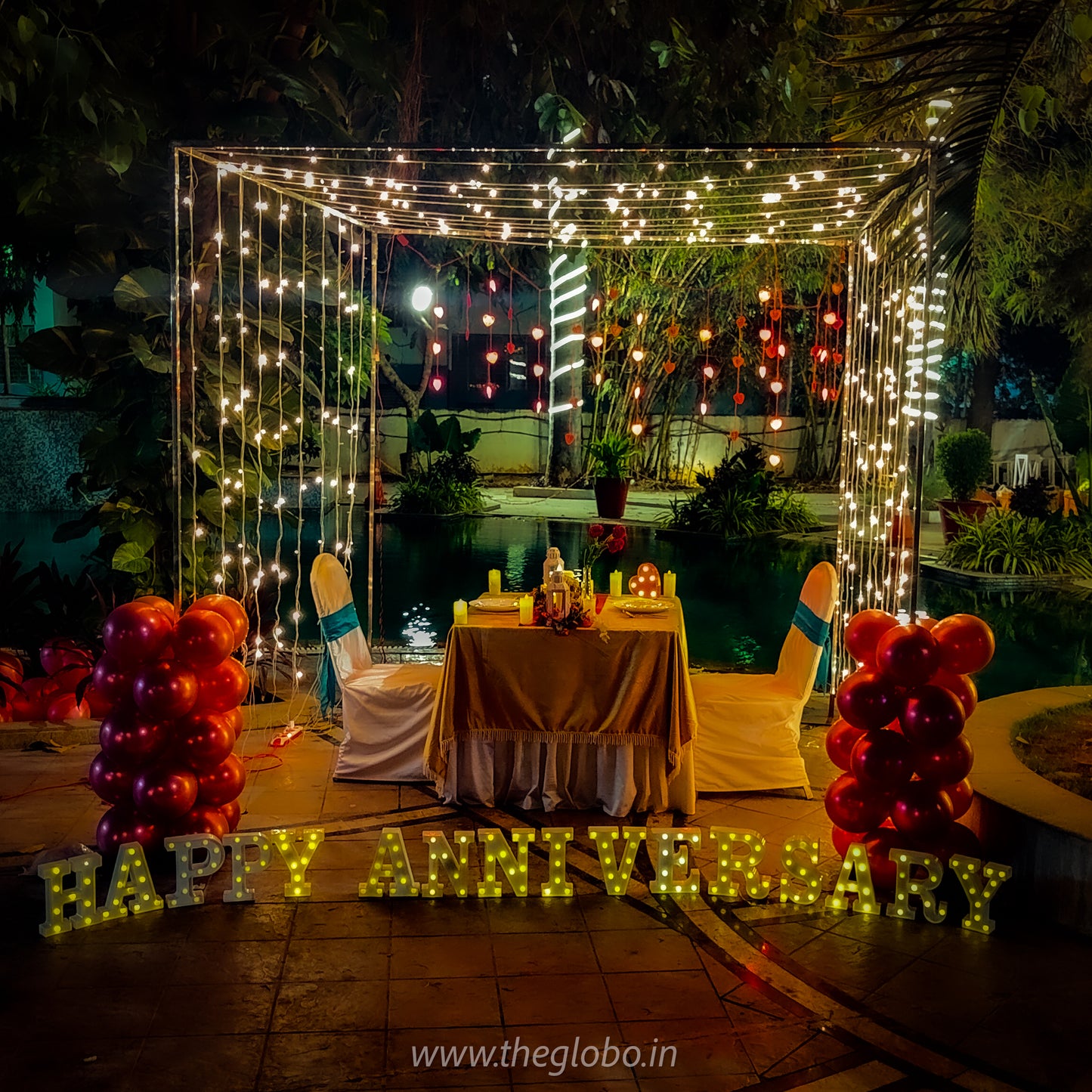 Exquisite birthday celebration in Hyderabad featuring a private cabana setup by the pool with romantic decorations.