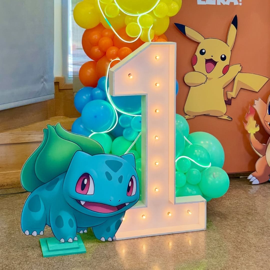 Pokemon birthday balloon decoration Hyderabad with Bulbasaur cutout, Pikachu backdrop, and rainbow balloon arch