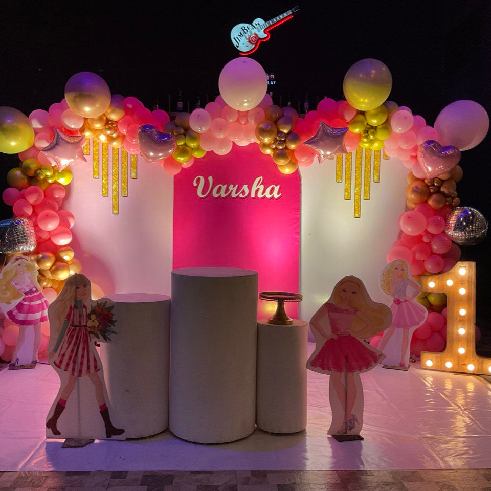 Stylish Barbie birthday decoration with pink balloon backdrop, star balloons, doll standees, and disco ball lights in Hyderabad.