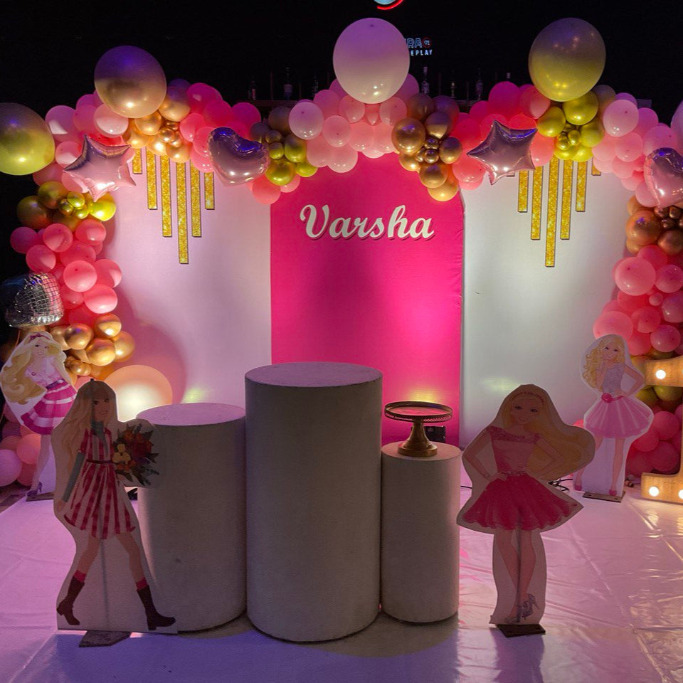 Balloon decoration in Hyderabad featuring Barbie theme setup with golden balloon arch, character cutouts, and birthday stage design.