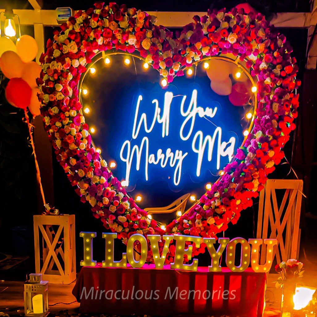 Candle light dinner in Hyderabad with luxurious proposal decorations, including roses, candles, and a red carpet entrance.