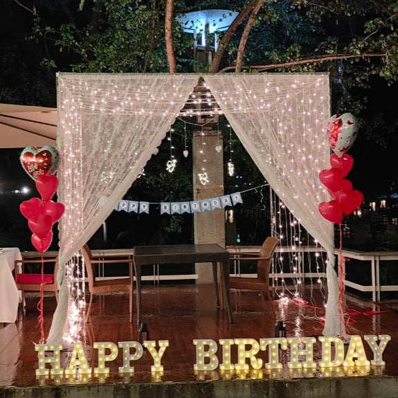 Beautifully decorated table with real roses and candles for a romantic candle light dinner in Hyderabad.