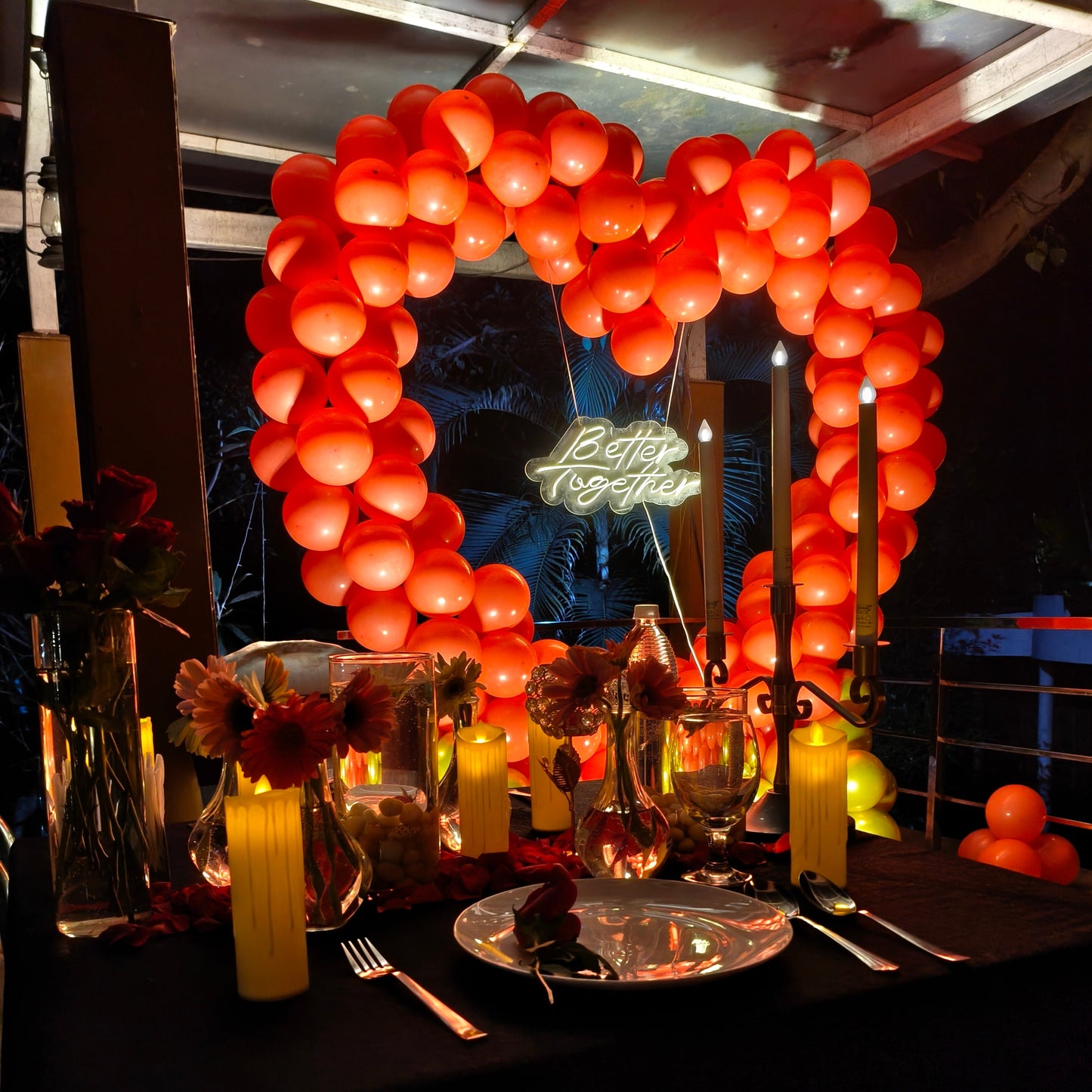 Romantic Candle light dinner set up with Heart shape balloon proposal decoration for romantic moment 