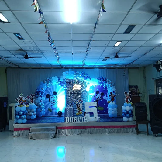 Mickey Mouse blue theme birthday decoration in Hyderabad with balloon cloud displays, Disney character cutouts, and shimmer wall backdrop.