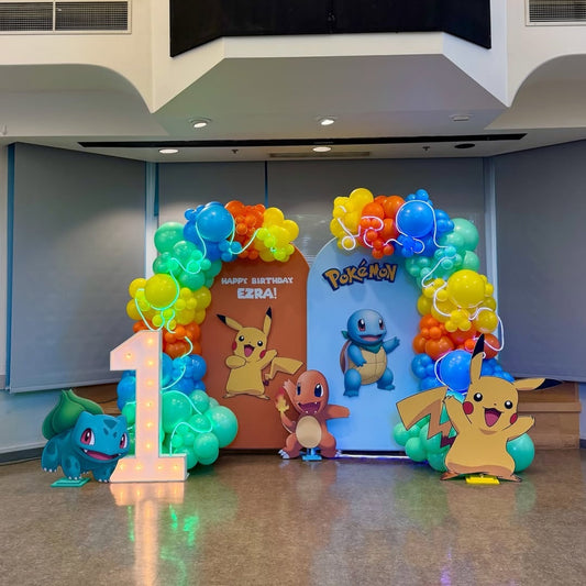 Pokemon kid's birthday decoration with rainbow balloon arch and Pikachu character cutouts in Hyderabad