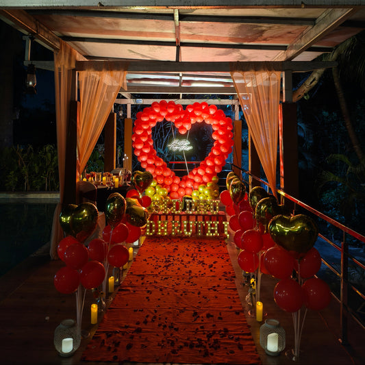 Romantic proposal decoration in red and gold theme at poolside with Candle light Dinner 