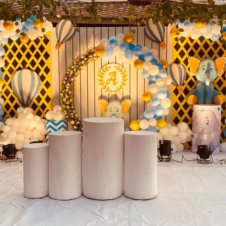 Baby Elephant Birthday Decoration setup with hot air balloon theme, blue and white balloon arch, cute elephant props, and ABC blocks for kids party in Hyderabad.
