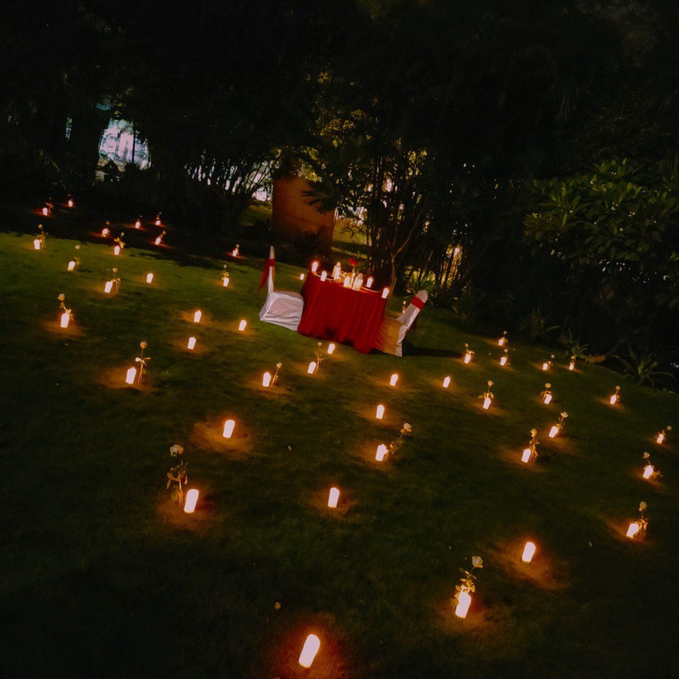 "Romantic open-air candle light dinner setup in Hyderabad, perfect for couples celebrating special moments."