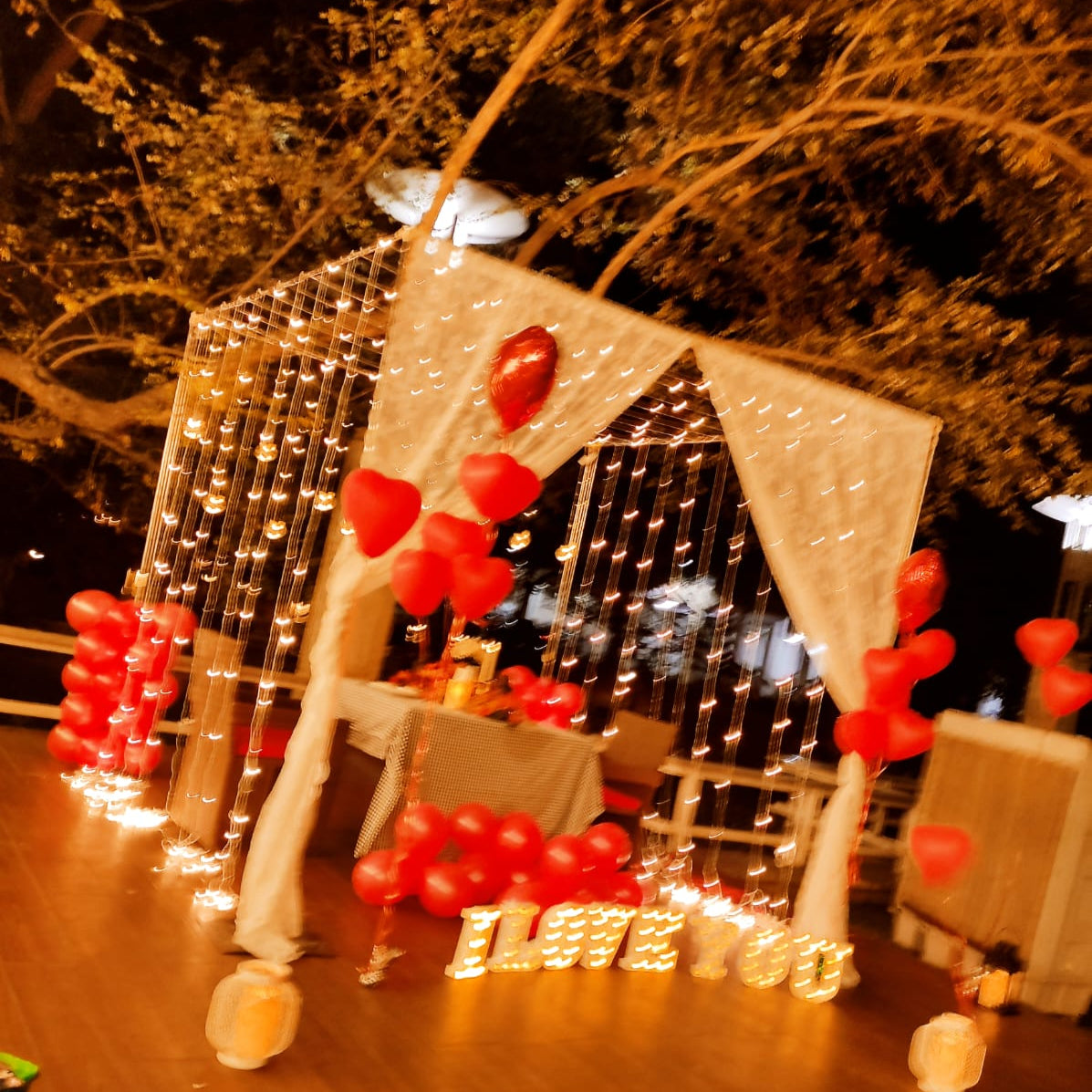 Anniversary celebration in Hyderabad with a private cabana setup, mirchi lights, and complimentary cake.
