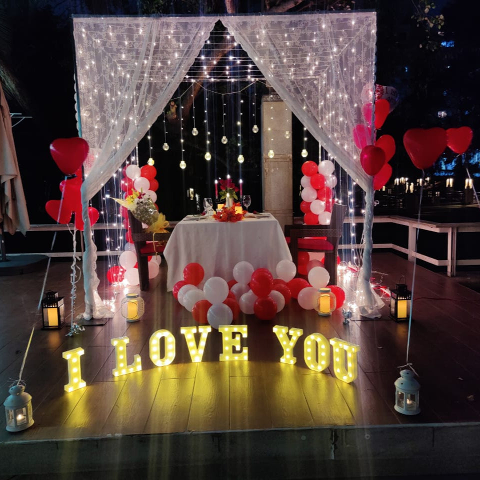 Premium cabana candle light dinner in Hyderabad featuring red carpet entrance and candle decorations.