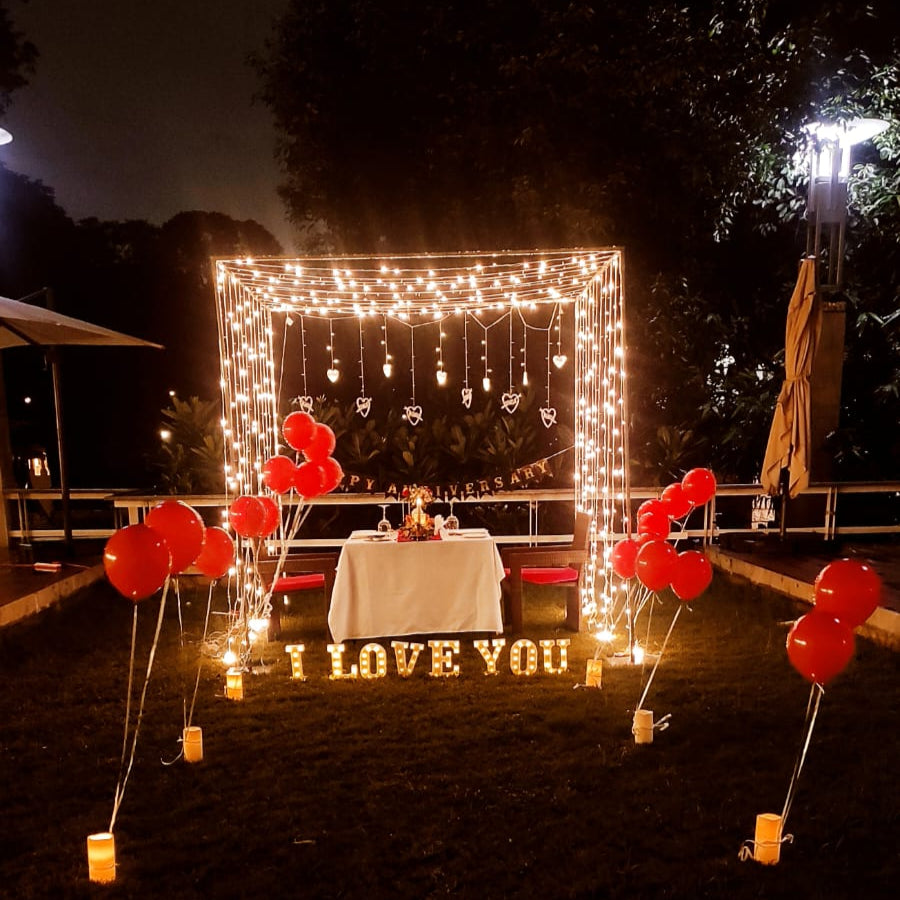 Romantic cabana setup for a Candle Light Dinner in Hyderabad with real roses and candles at Ellaa Hotel, Gachibowli.